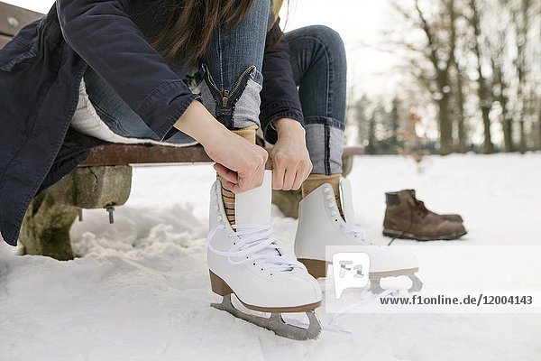 Woman putting on her ice skates