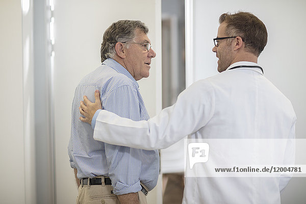 Doctor talking to senior patient in medical practice