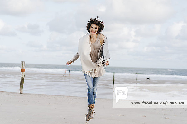 Happy woman running on the beach