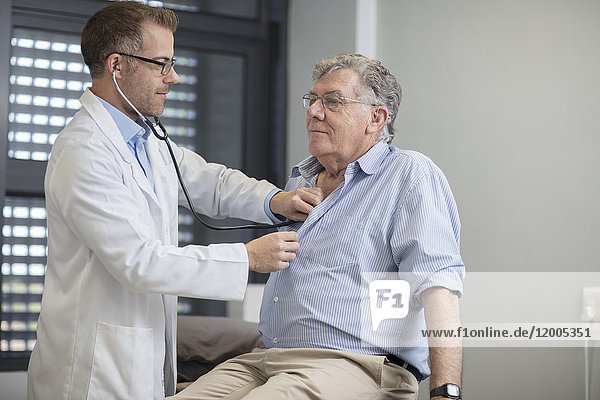 Doctor examiming senior patient in medical practice