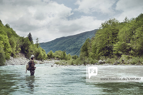 Slovenia  man fly fishing in Soca river