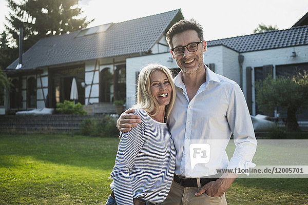 Happy couple in the garden of their country house