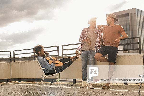 Three friends having a rooftop party