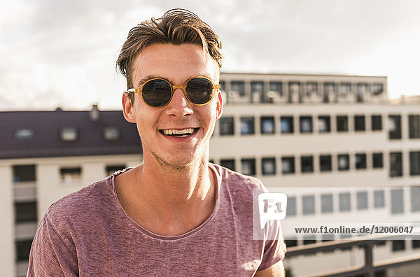 Portrait of happy young man on rooftop