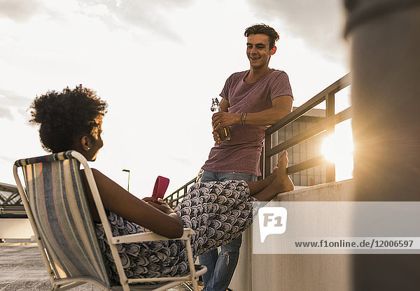 Young couple socializing on rooftop