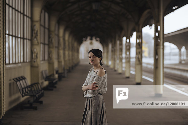 Portrait of serious Caucasian woman at train station