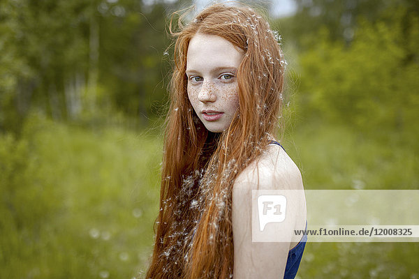 Caucasian girl with dandelion seeds hair