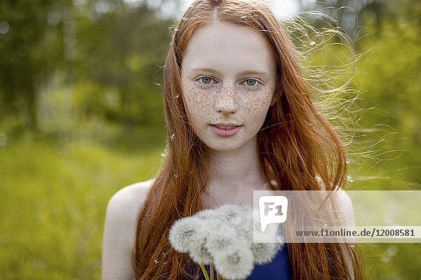 Caucasian girl with dandelion seeds hair