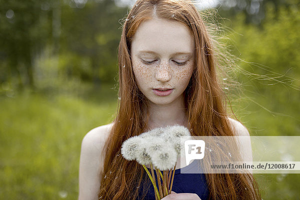 Caucasian girl with dandelion seeds hair