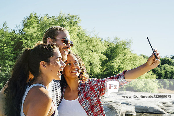 Freunde posieren für ein Handy-Selfie im Freien
