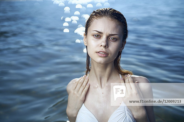 Serious woman wearing a bikini in ocean