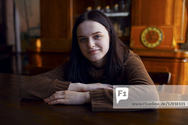 Smiling Caucasian girl sitting at table