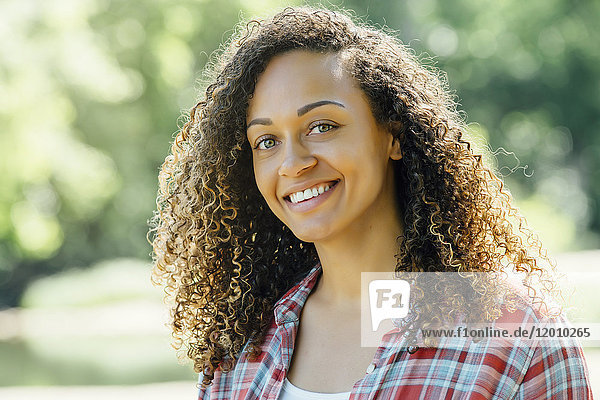 Portrait of smiling mixed race woman outdoors