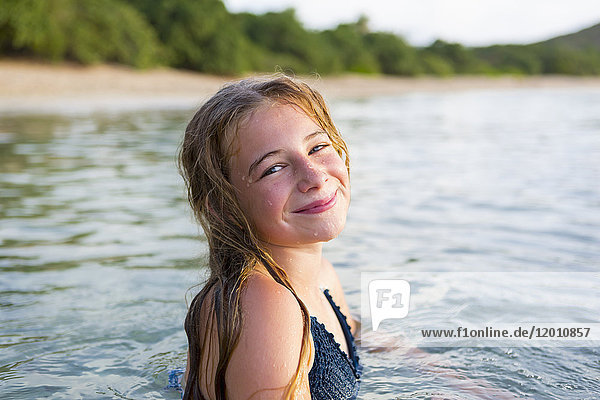 Portrait of smiling Caucasian girl swimming