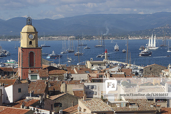 France  Var department  a large view on the old roofs and the church of the city of Saint-Tropez with in background yachting boats