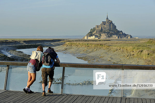 France  Lower Normandy Region  Manche Department  Mont St-Michel seen from the dam on Couesnon river  couple of visitors.
