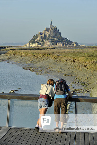 France  Lower Normandy Region  Manche Department  Mont St-Michel seen from the dam on Couesnon river  couple of visitors.