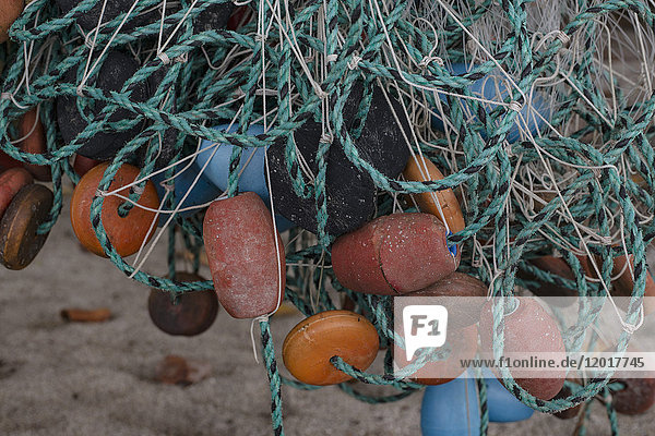Close-up of tangled fishing net and buoys at beach  Tayrona  Columbia