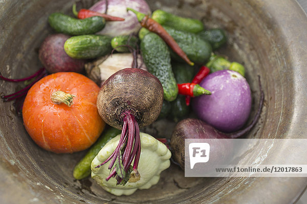 Directly above shot of various vegetables in container on table