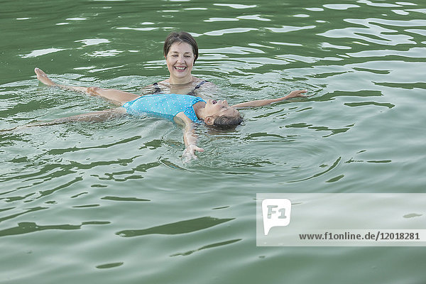 High angle view of grandmother and granddaughter enjoying in swimming pool