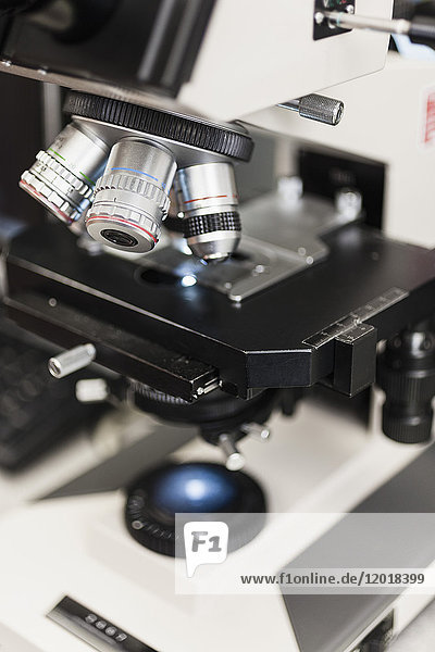 Close-up of microscope at table in laboratory