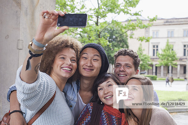 Smiling young woman taking selfie with multi-ethnic friends  Berlin  Germany