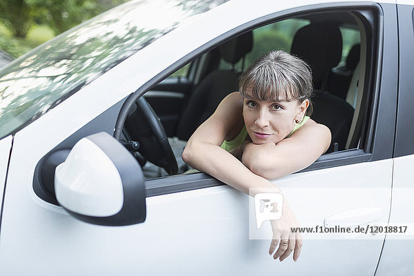 Portrait of woman resting in car