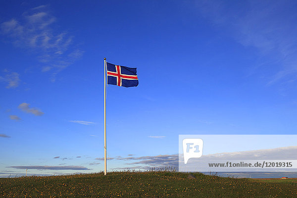 Iceland flag in blue sky.