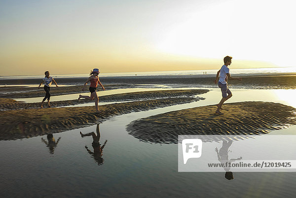 Normandie  Drei Kinder spielen am Strand