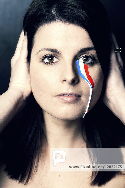 France woman  tear with the colors of the French flag.