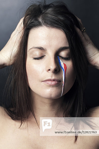 France woman  tear with the colors of the French flag.