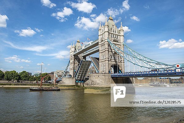 Ship passes open tower bridge  passageway  open baskules  Thames  Southwark  London  England  Great Britain