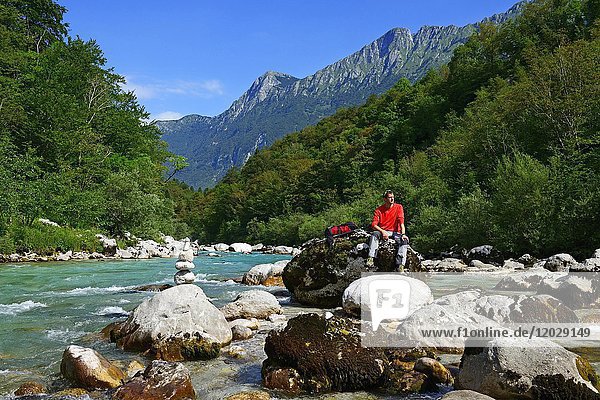 Hikers resting at the river Soca  near Kobarid  Slovenia  Europe