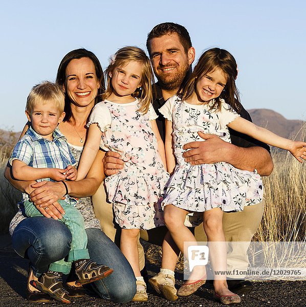Familienporträt  Eltern mit drei kleinen Kindern  Namibia  Afrika