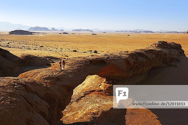 Trail runners at Rock-Arch Al Kharza  Wadi Rum  Jordan  Asia