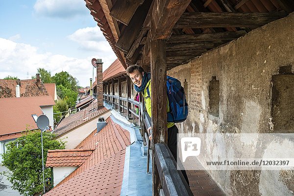 Young man on the old city wall  Nördlingen  Swabia  Bavaria  Germany  Europe