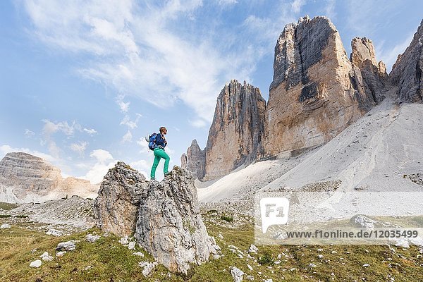 Wanderer steht auf Felsen  Nordwände der Drei Zinnen von Lavaredo  Sextner Dolomiten  Südtirol  Trentino-Südtirol  Südtirol  Italien  Europa
