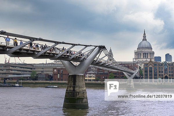 Millennium Bridge across the River Thames with St. Paul's Cathedral  London  England  UK