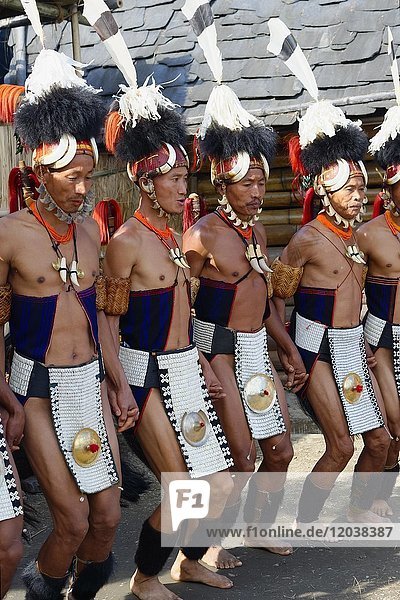 Naga tribal men in traditional clothing performing ritual dances  Kisima Nagaland Hornbill festival  Kohima  Nagaland  India  Asia