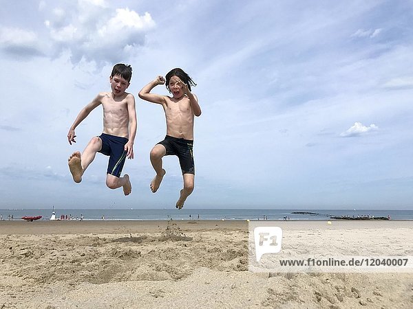 Children jumping on the beach  Knokke-Heist  Vlaanderen  Belgium  Europe