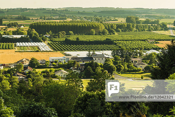 View of fields orchards and polytunnels in summer seen from this important hilltop town Duras Lot-et-Garonne France Europe