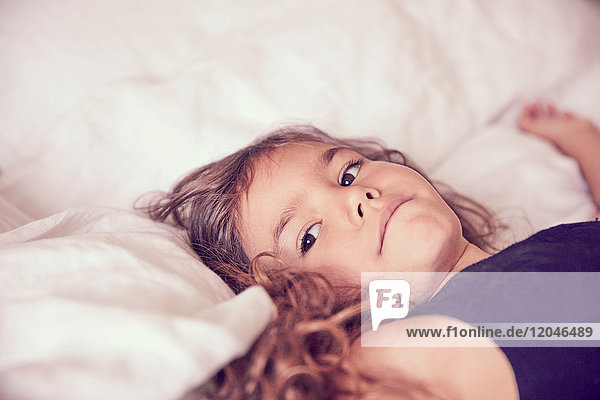 Young girl lying on bed  pensive expressions