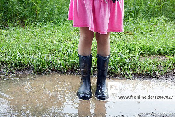 Girl standing in mud  low section