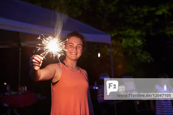 Girl outside at night  using sparkler