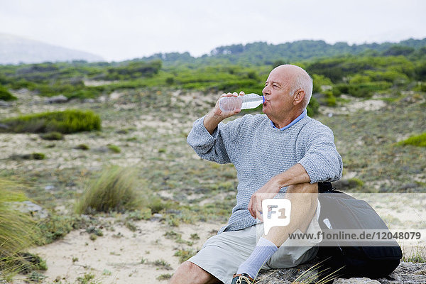 Hiker Taking a Break  Drinking a Bottle of Water