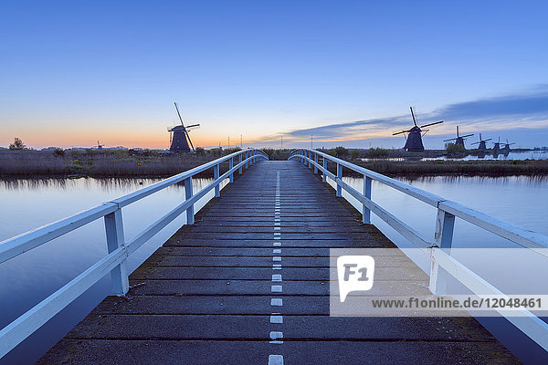 Wooden Bridge with Windmills at Dawn Kinderdijk South Holland Netherlands