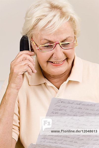Woman with Letter and Celllular Phone