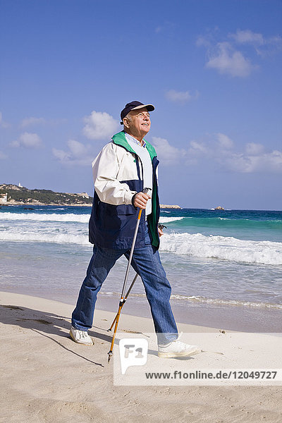 Man Nordic Walking on the Beach