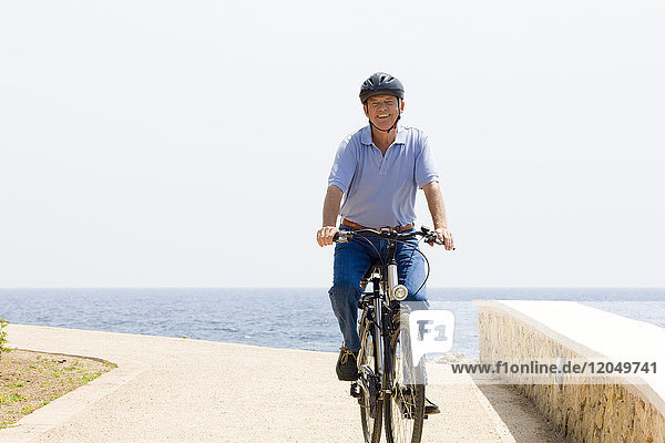 Man Riding Bicycle by Water