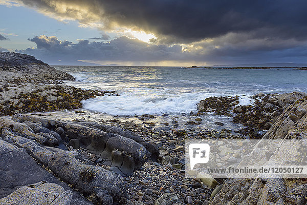 Surf along the Scottish coast at sunrise in spring at Mallaig in Scotland United Kingdom